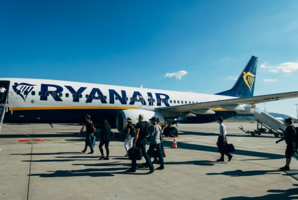 Blog 7 people walking near white and blue airplane under blue sky during daytime